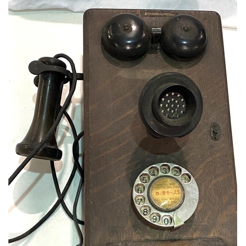 104 - An early 20th century Western Electric made in the USA, oak cased wall telephone with bakelite fitti... 