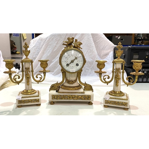 109 - A late 19th/early 20th century clock garniture, Louis XVI style in ormolu and white marble, the cent... 