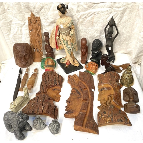 35 - A selection of African/Asian wood carved figures; masks; etc.
