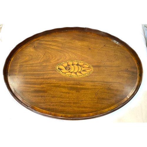 4 - A mahogany oval 2-handled tray with central shell motif