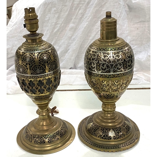 65 - A Middle Eastern pair of brass table lamps of baluster form with silvered line and extensive fretwor... 