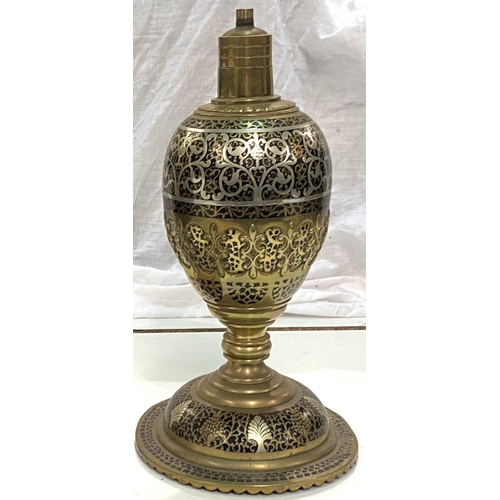 65 - A Middle Eastern pair of brass table lamps of baluster form with silvered line and extensive fretwor... 