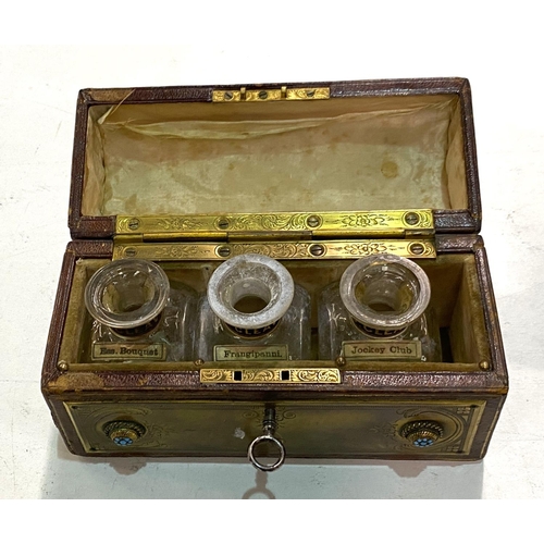 79 - A late 19th century leather and brass bound box with bottles fitted internally (spaces missing) with... 