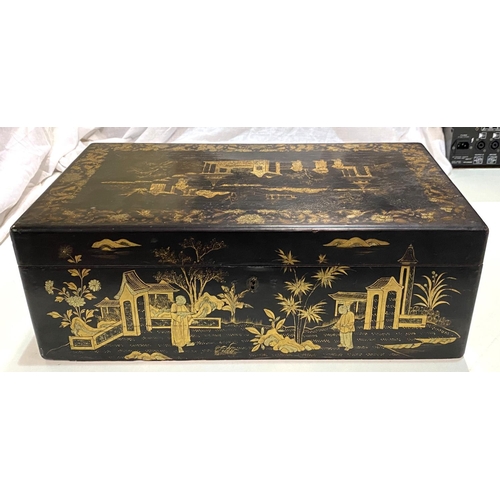 82 - A Japanese lacquer writing box with gilt decoration of pagodas and domestic scenes.