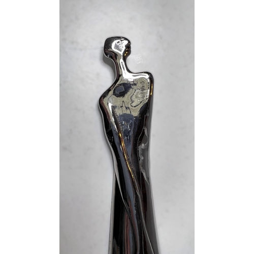 83 - A white metal modernist unusual shoehorn in the form of a female, signed Carrol Boyes, South Africa,... 