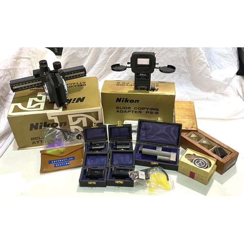 97 - Nikon F boxed accessories, a selection of photography filters and accessories; various camera batter... 