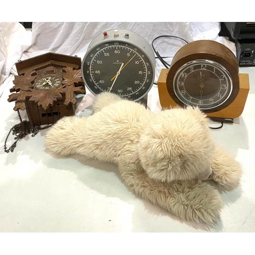 99 - A Junghans Dark Room step clock; a cuckoo clock, another clock and a Steiff polar bear.