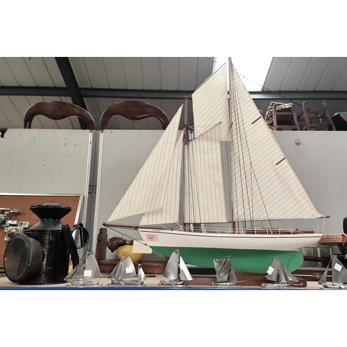 131 - A 19th century railway lantern; a 2 masted model yacht