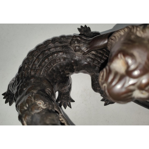 140 - A 19th century Chinese/Japanese bronze group:  tiger attacking a crocodile, rectangular seal mark to... 