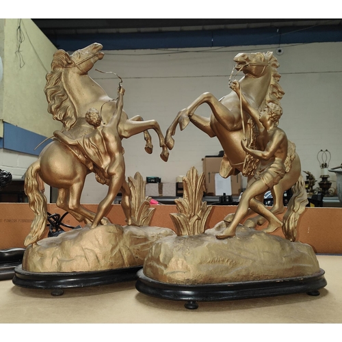 142A - A pair of gilt painted Spelter Marly horses on wooden plinths (leg a.f)