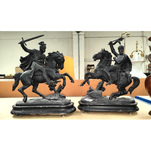 143 - A pair of Spelter knights on horseback on wooden plinths