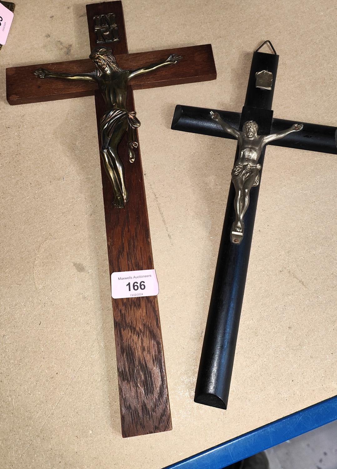 Two wall hanging crucifixes, one ebonised with gilt Christ, the other
