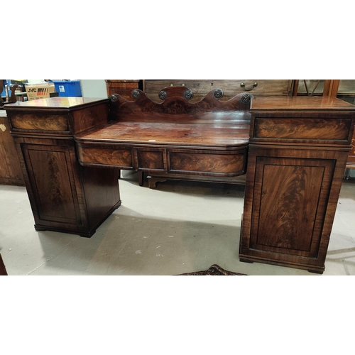 898 - A Georgian figured mahogany sideboard with breakfront on twin pedestals, 2 central bow front drawers... 