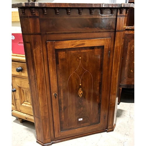 901 - A Georgian mahogany corner cupboard with Sheraton style inlay, the straight front enclosed by single... 