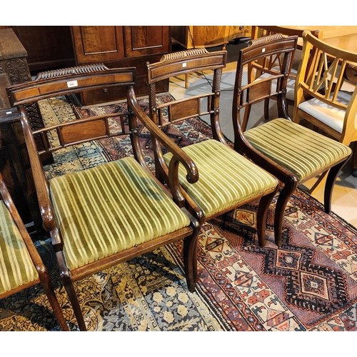 896 - A set of 7 (6 + 1) Regency mahogany dining chairs with rope work backs and side columns, on sabre le... 