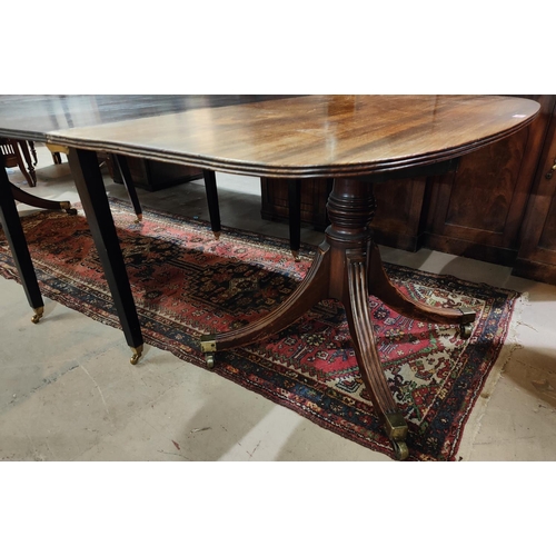 905 - A 19th century Georgian style mahogany dining table, with extending 'D' ends, twin pedestals with tu... 