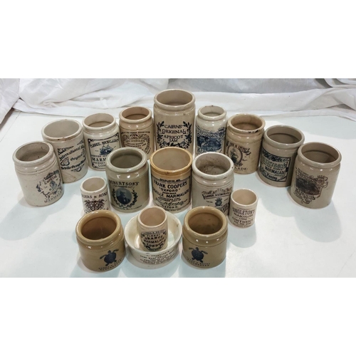 86 - A collection of stoneware jars with later transfer advertising labels.