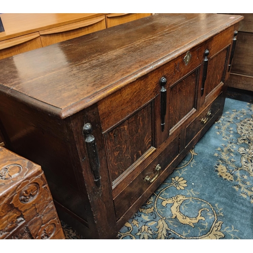 913 - A 19th century oak chest with panel front, hinged lid and two drawers below, length 134cm