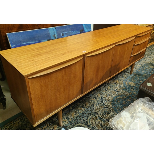 916 - A mid 20th century G-Plan style teak, long low sideboard with three drawers, double and single cupbo... 