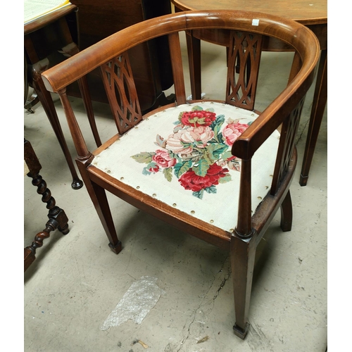 902A - An Edwardian tub shaped armchair in inlaid mahogany