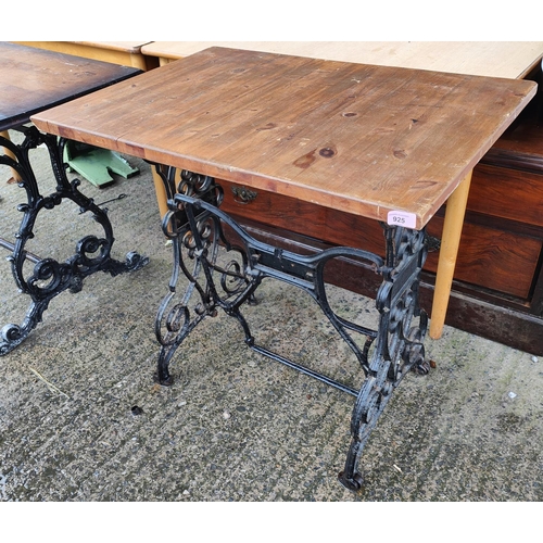 925 - A table with cast iron treadle sewing machine base and a stained wooden top and a white metal and gl... 