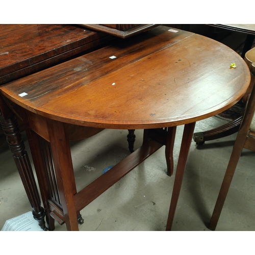 877 - An Edwardian oval walnut Sutherland table on square splay legs