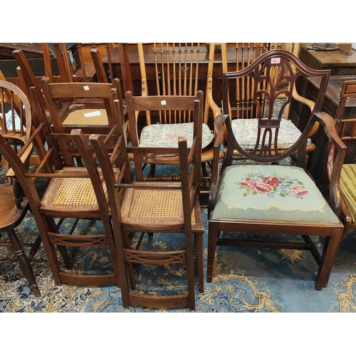 905 - A 19th century mahogany shield back armchair , 4 cane seat bedroom chairs; a Georgian style oval dro... 