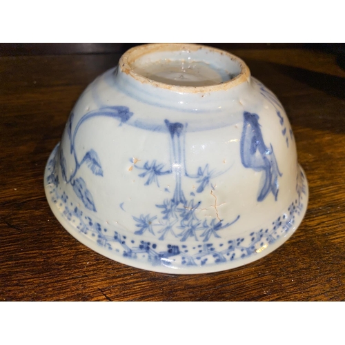 515A - A Chinese possibly ming period blue and white bowl with plants and flowers, (rim restored)