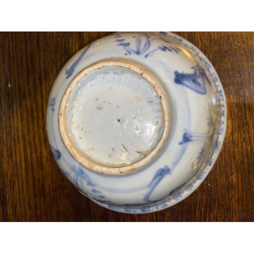 515A - A Chinese possibly ming period blue and white bowl with plants and flowers, (rim restored)