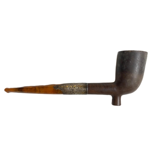 118A - A 19th century meerschaum style pipe with a silver mounted amber stem, cased.