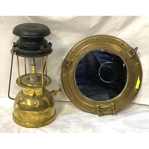 2A - A vintage hanging port hole mirror and a brass vintage lamp.