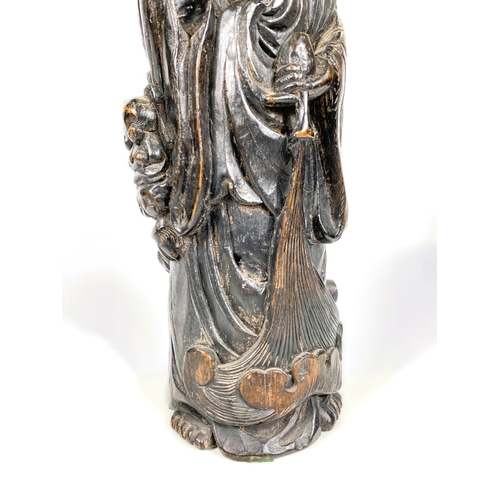 483 - A Chinese carved bamboo figure of Guanyin with attendant Foo Lion, 37cm