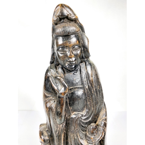 483 - A Chinese carved bamboo figure of Guanyin with attendant Foo Lion, 37cm