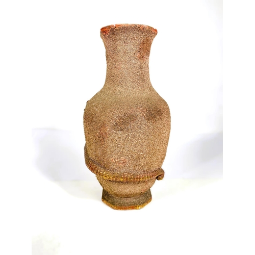 484 - A Chinese octagonal baluster vase with sand grain finish, applied Kylin dragon in red and gilt, 28cm