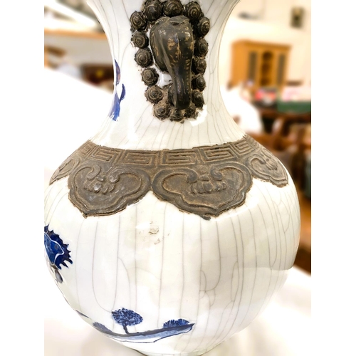 485A - A Chinese porcelain baluster shaped vase decorated in under glaze blue with battle scene, bronzed ef... 