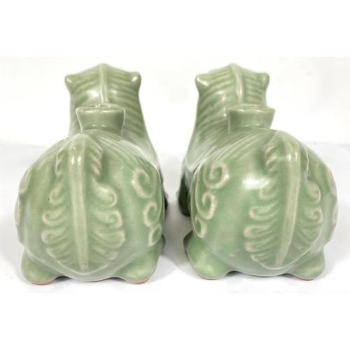 487A - A pair of Chinese celadon glaze candleholders in the form of Shi Shi, 13cm length 