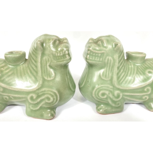 487A - A pair of Chinese celadon glaze candleholders in the form of Shi Shi, 13cm length 