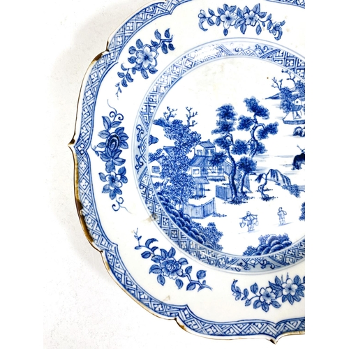 488A - A Chinese porcelain plate with shaped rim decorated in under glaze blue with genre scene, 22cm