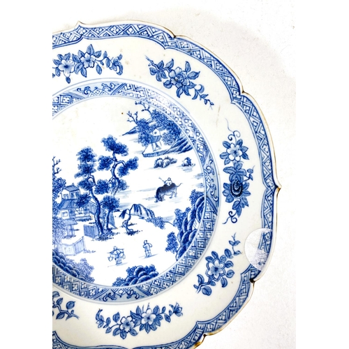 488A - A Chinese porcelain plate with shaped rim decorated in under glaze blue with genre scene, 22cm