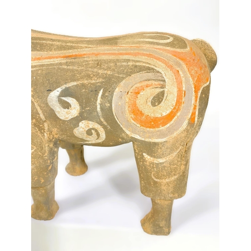 489 - A Chinese under glazed pottery figure of a goat in the archaic style, painted decoration, 30cm high