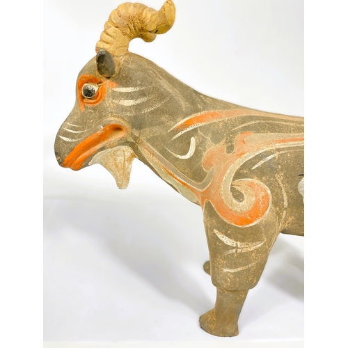 489 - A Chinese under glazed pottery figure of a goat in the archaic style, painted decoration, 30cm high