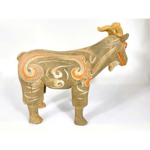 489 - A Chinese under glazed pottery figure of a goat in the archaic style, painted decoration, 30cm high