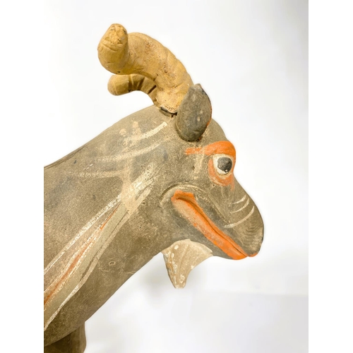 489 - A Chinese under glazed pottery figure of a goat in the archaic style, painted decoration, 30cm high