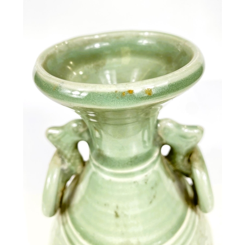 492 - A Chinese celadon glazed vase with Kyin dragon and ring handles, 22cm