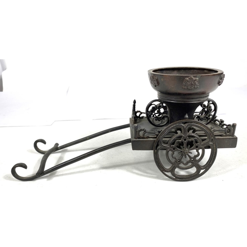 492A - A Japanese bronze table ornament in the form of a rickshaw, 27cm length