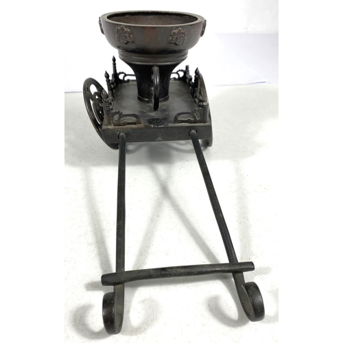 492A - A Japanese bronze table ornament in the form of a rickshaw, 27cm length