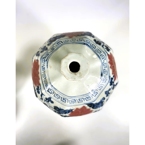 493 - A Chinese porcelain octagonal meiping vase decorated in underglaze blue and iron red with stylised f... 