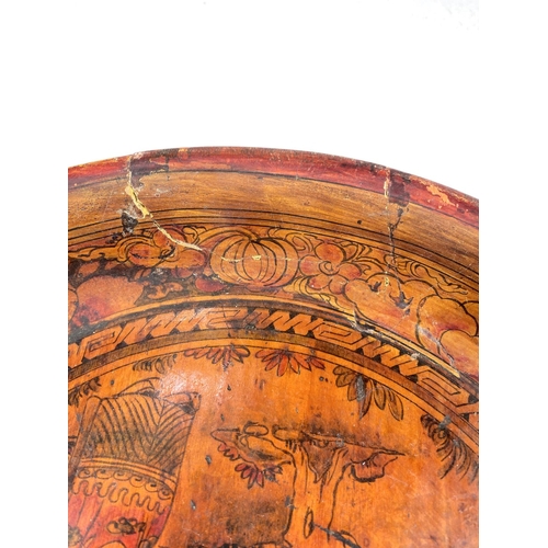 494C - An unusual 19th century Chinese wooden painted dish with figures among clouds (some cracking) 29cm