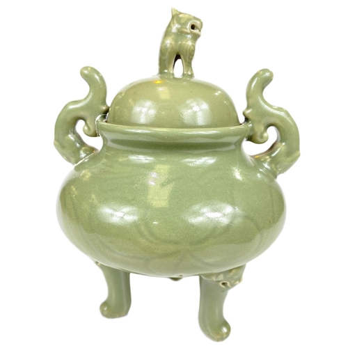 495B - A Chinese celadon glaze lidded centre, three legged with mythical beast finial, ht. 25cm 