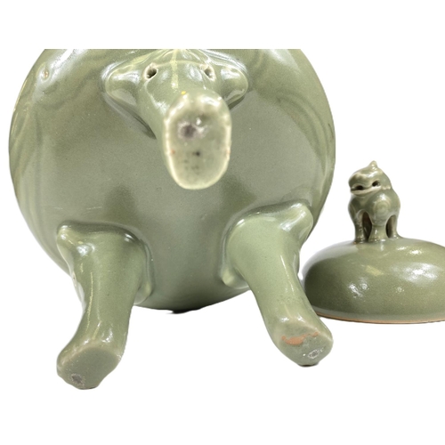 495B - A Chinese celadon glaze lidded centre, three legged with mythical beast finial, ht. 25cm 